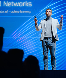 Image of a man speaking on a stage