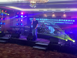 Band performing on stage at the Rock School Seminar and Concert in China, powered by the QSC TouchMix